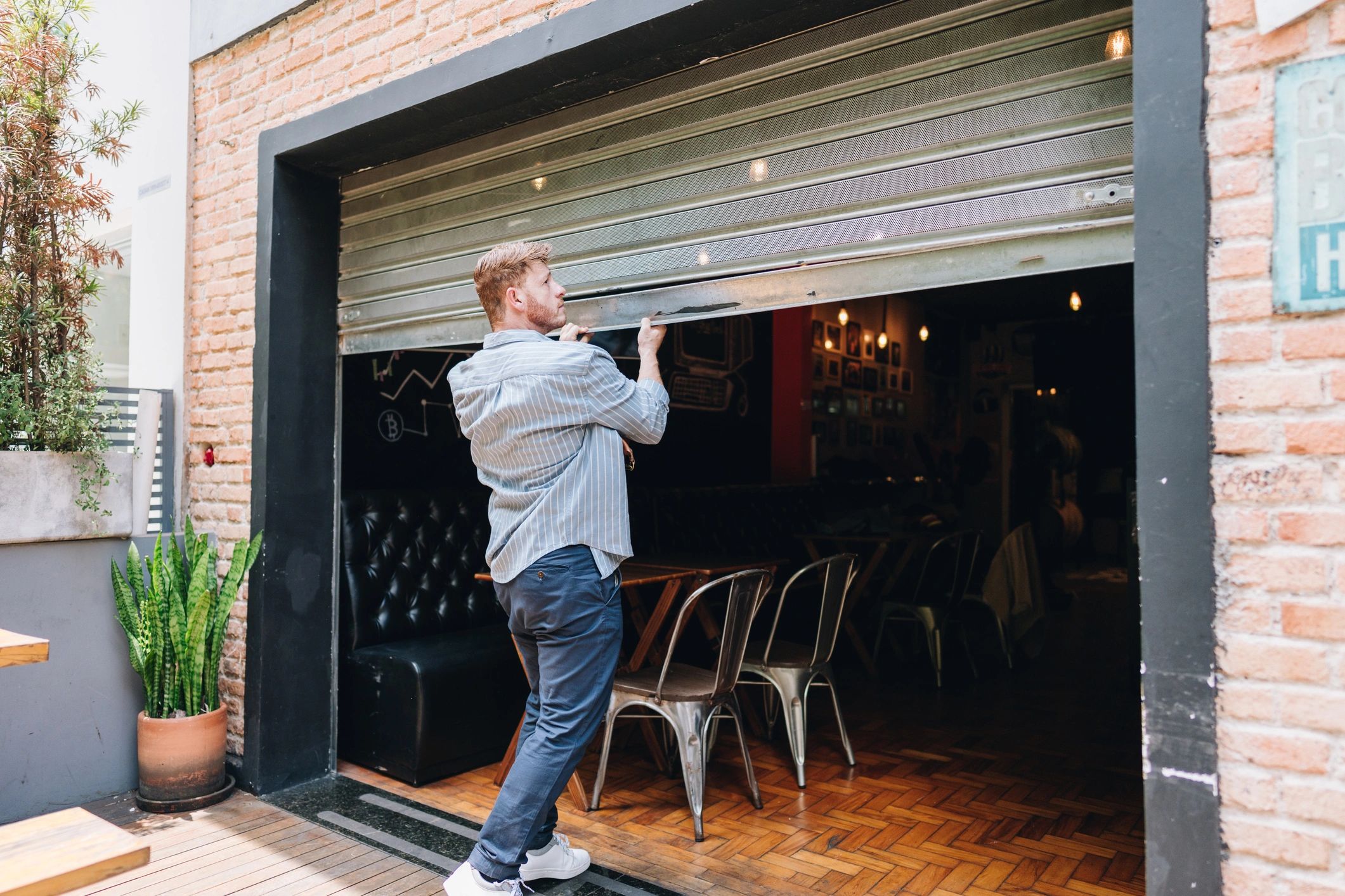 Man closing a garage-style door