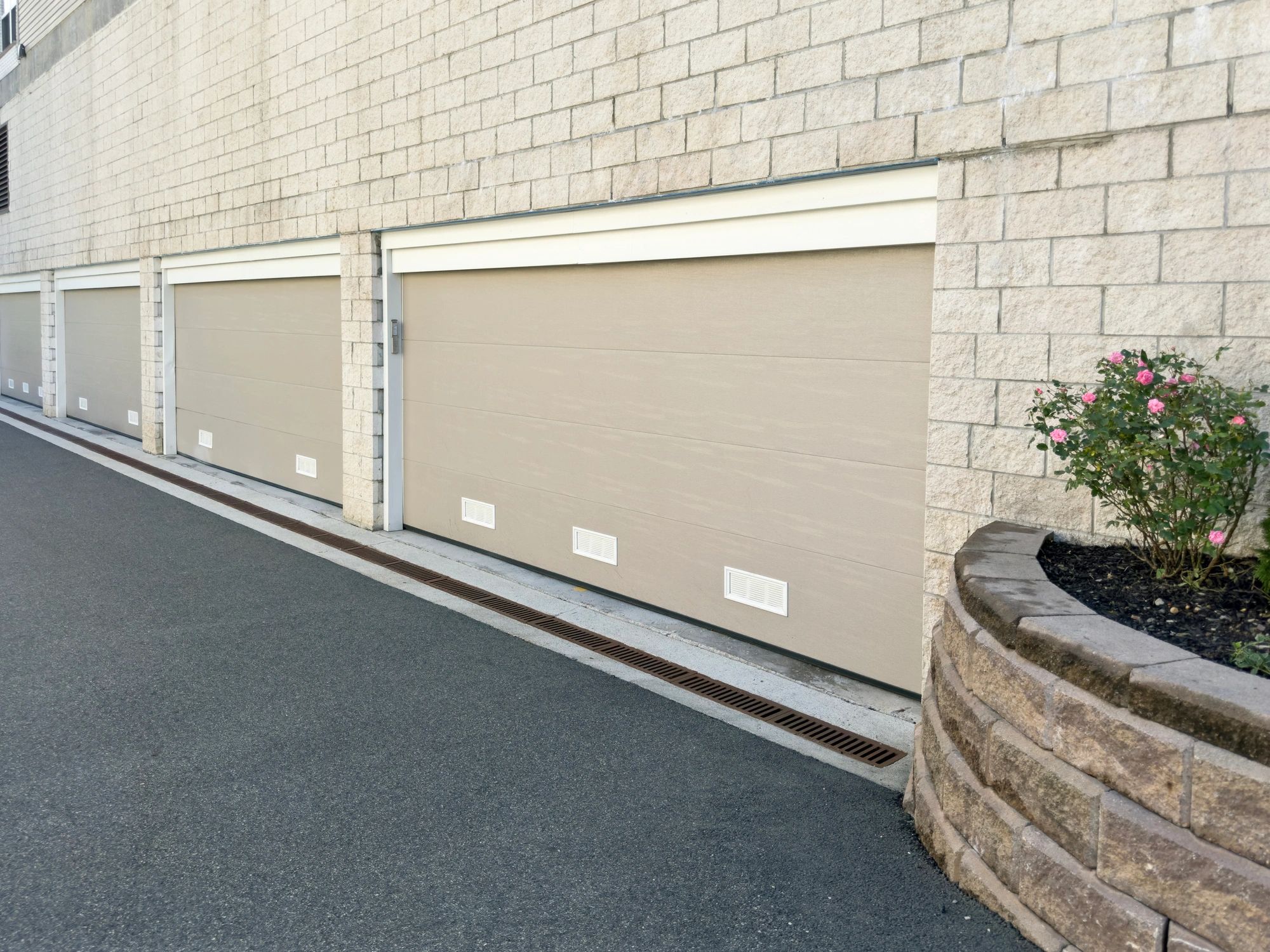 Garage door and roller shutter supply image showing multiple fitted doors and access systems
